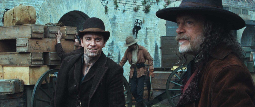 MICHAEL FASSBENDER as Burke and JOHN MALKOVICH as Quentin Turnbull in Warner Bros. PicturesÕ and Legendary PicturesÕ action adventure ÒJONAH HEX,Ó a Warner Bros. Pictures release. TM & © DC Comics.