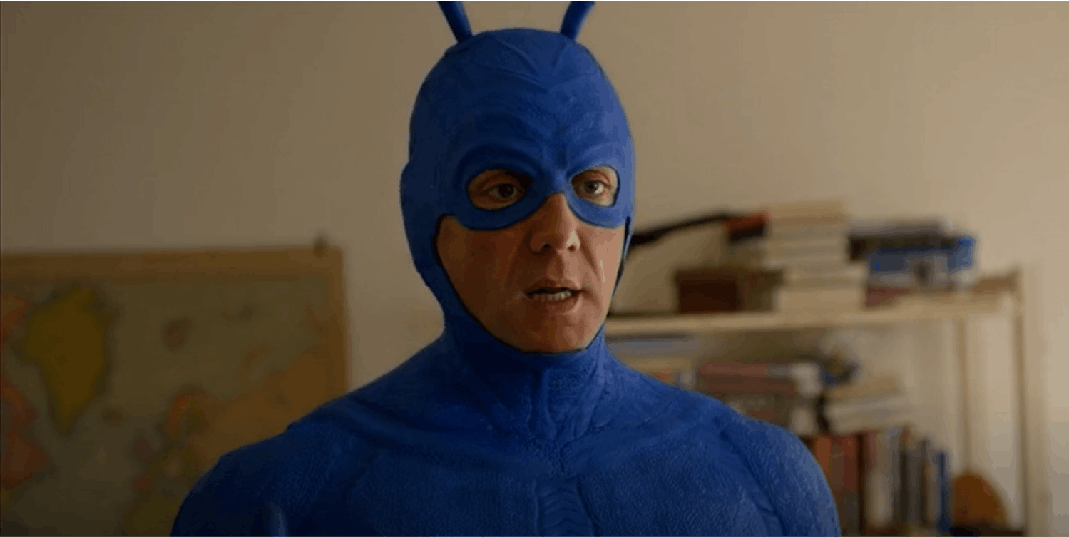 Why Does the Tick Never Take Off His Mask?